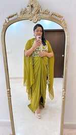 Pure crepe hand work blouse and a cape paired with a pleated skirt in green