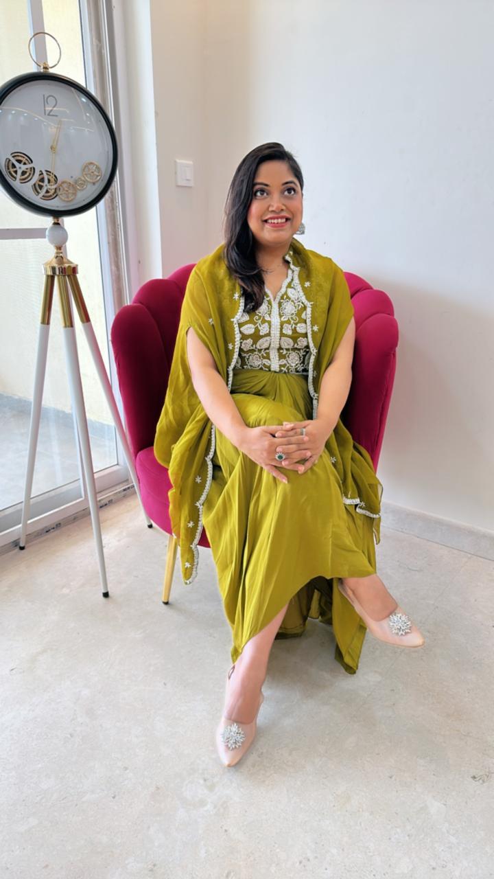 Pure crepe hand work blouse and a cape paired with a pleated skirt in green