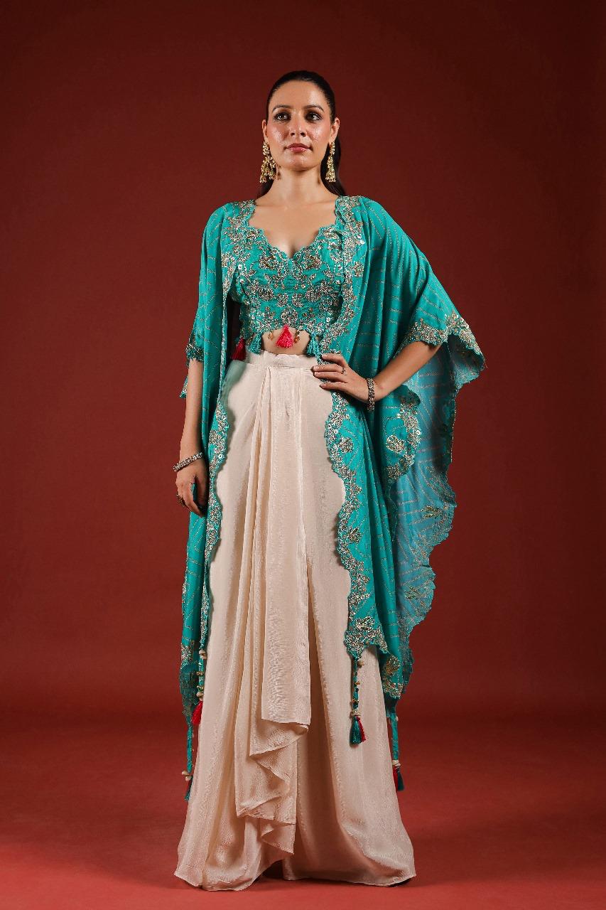 Beautiful chinon pleated skirt paired with embellished blouse and a cape (extra margin available) in blue