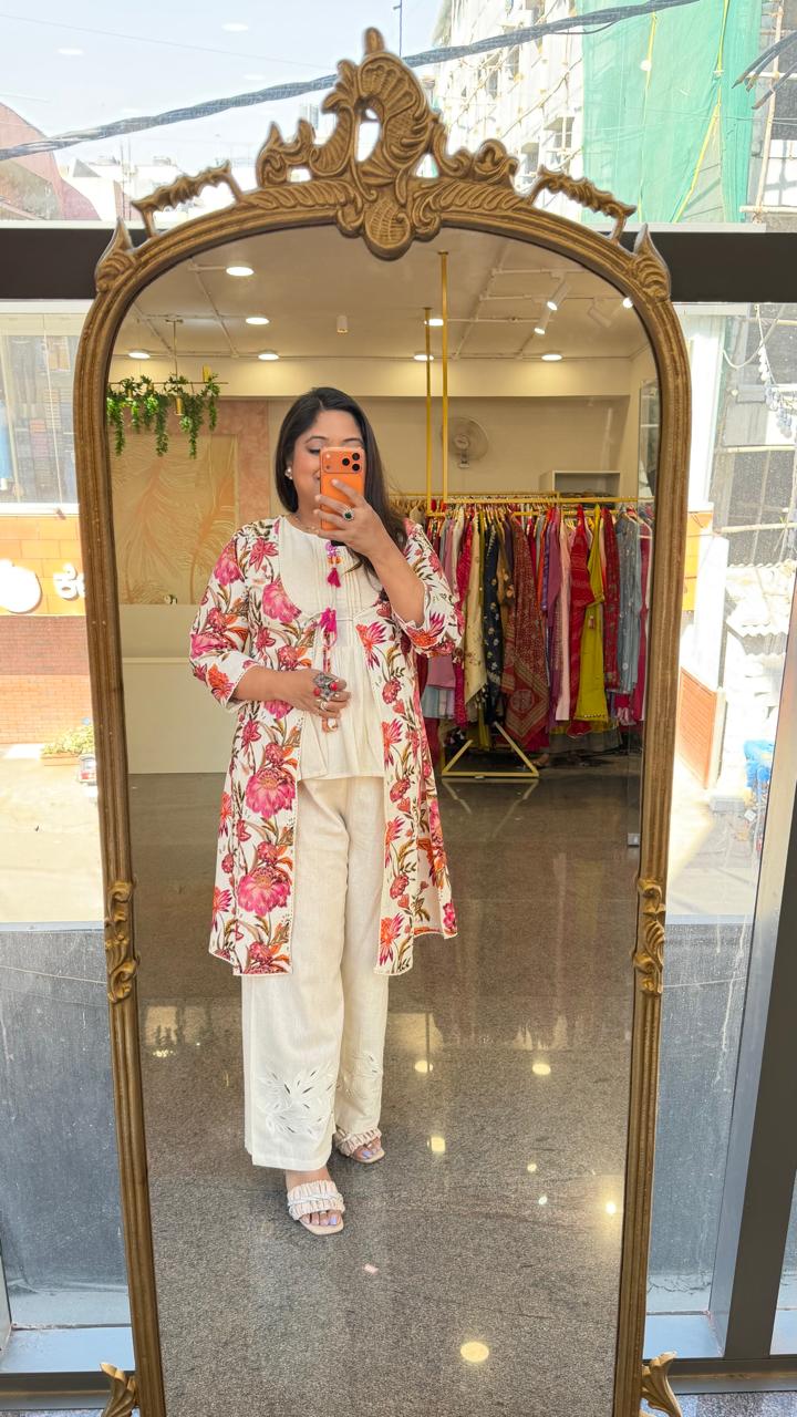 Cutwork pant paired with inner and a floral jacket in pink