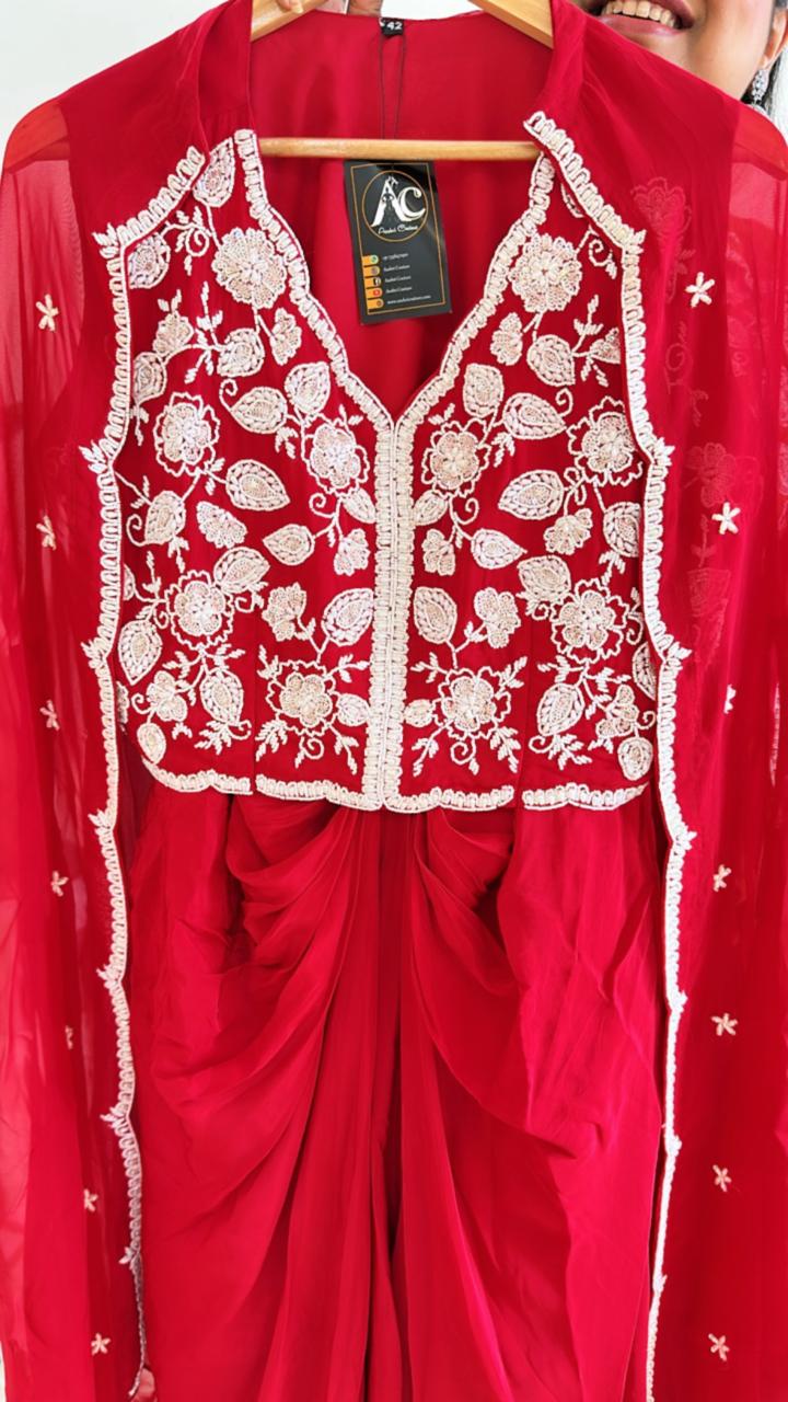 Pure crepe hand work blouse and a cape paired with a pleated skirt in red