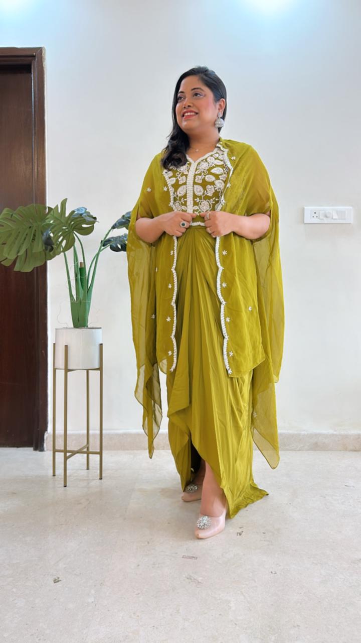 Pure crepe hand work blouse and a cape paired with a pleated skirt in green