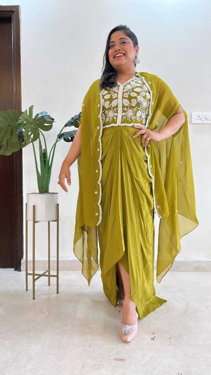Pure crepe hand work blouse and a cape paired with a pleated skirt in green