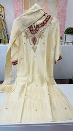 Dola silk hand work suit set paired with Banarasi dupatta in yellow