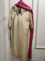 Shimer tissue suit paired with pink patola dupatta