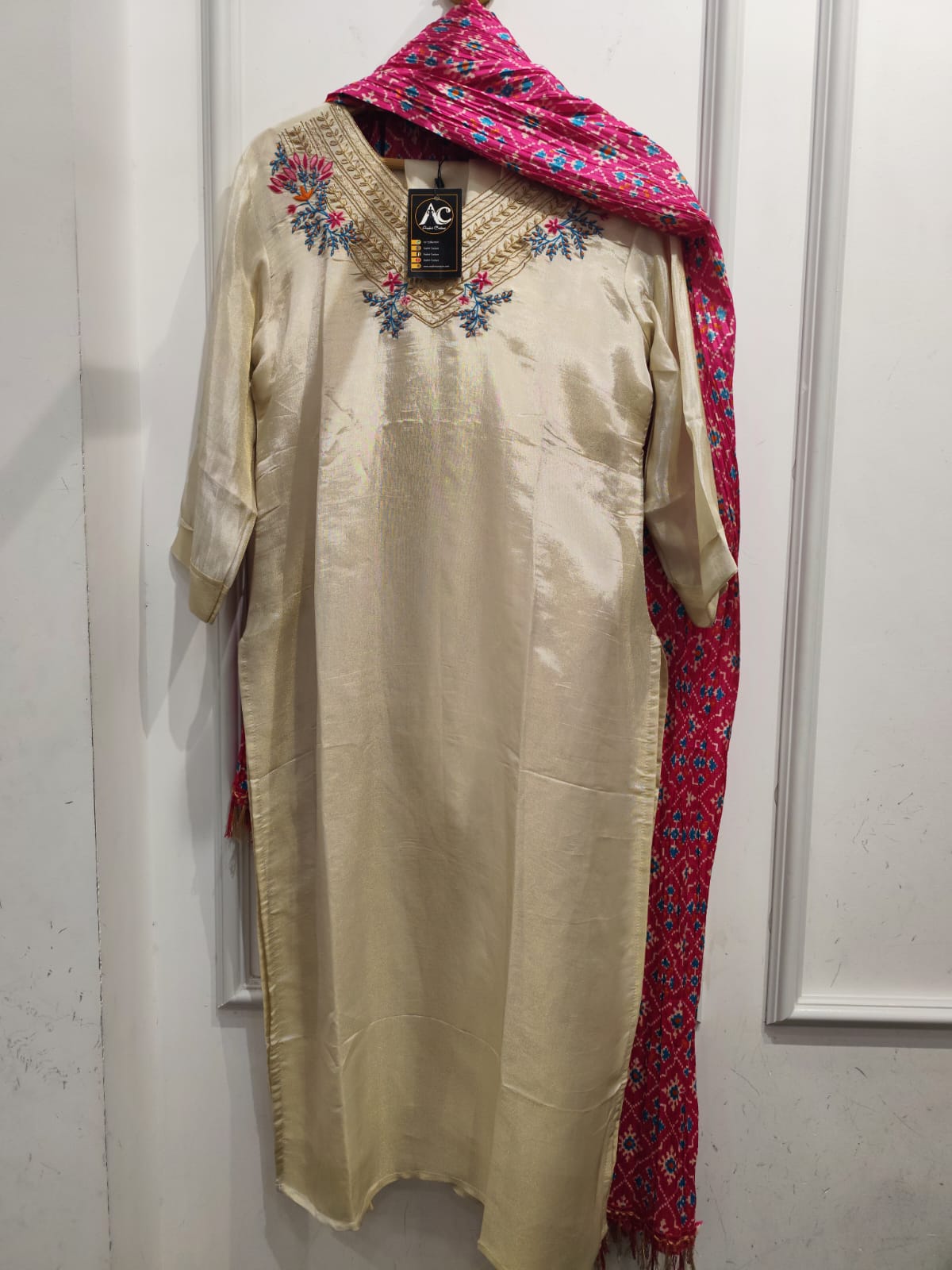 Shimer tissue suit paired with pink patola dupatta