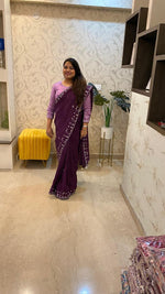 Pretty soft silk saree in wine with handwork comes with stitch blouse
