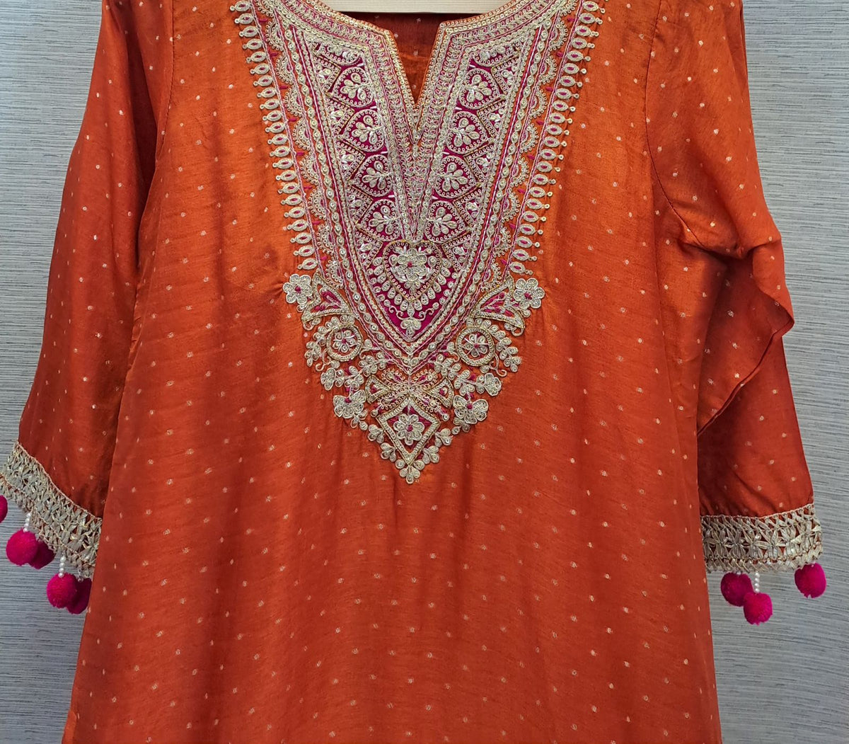 Premium dola silk with zari weaving in the entire kurta and dupatta with zari detailing n Pom Pom lace in orange